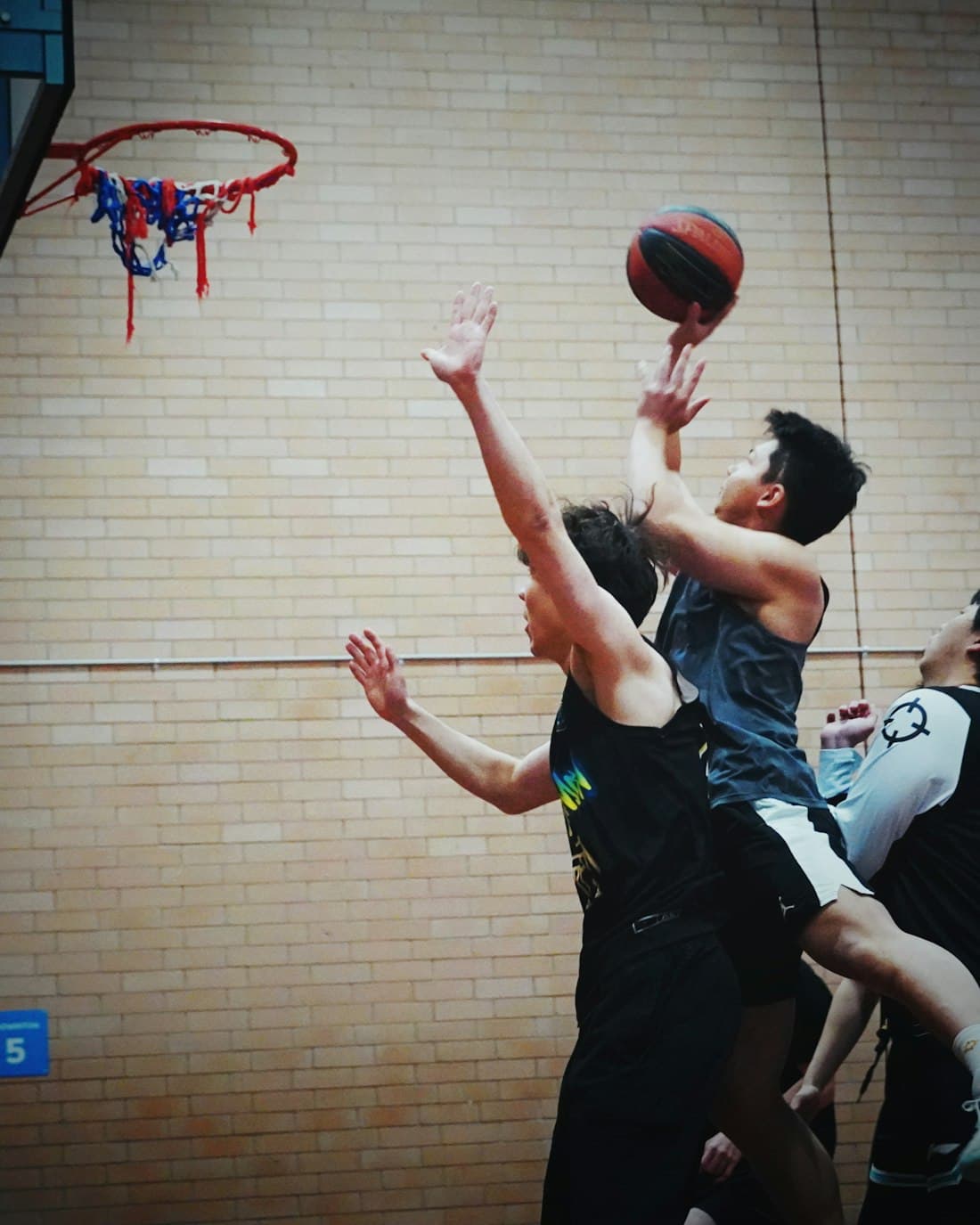 Players competing in an indoor basketball game