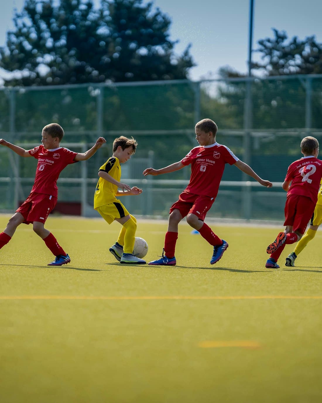 A youth football team in a match on the pitch